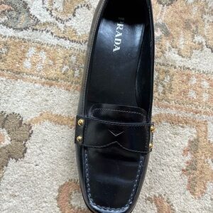 Prada Women's Elegant Black Loafers with Gold Accents
